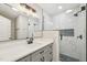 Modern bathroom featuring a gray vanity, marble shower with hexagon floor tiles, and updated fixtures at 4436 Talcott Dr, Durham, NC 27705