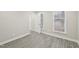 Spacious bedroom with grey wood flooring and natural light at 4436 Talcott Dr, Durham, NC 27705