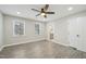 Bright bedroom with a ceiling fan and an en suite bathroom featuring gray wood flooring at 4436 Talcott Dr, Durham, NC 27705