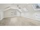 Bright bedroom featuring modern flooring, skylights, and a ceiling fan at 4436 Talcott Dr, Durham, NC 27705