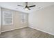 Bright bedroom featuring two windows, ceiling fan, and contemporary flooring at 4436 Talcott Dr, Durham, NC 27705