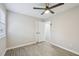 Bedroom featuring modern flooring, ceiling fan, and closet with view to adjacent room at 4436 Talcott Dr, Durham, NC 27705