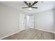 Bedroom featuring a ceiling fan, closet, and gray wood flooring throughout at 4436 Talcott Dr, Durham, NC 27705