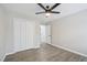 Spacious bedroom with a ceiling fan, closet, and contemporary flooring at 4436 Talcott Dr, Durham, NC 27705