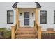 Close up of brick steps leading to the front door, wooden posts, and brick accent landscaping at 4436 Talcott Dr, Durham, NC 27705