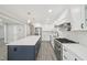 Bright kitchen with an island, stainless steel refrigerator, white cabinets, and granite countertops at 4436 Talcott Dr, Durham, NC 27705