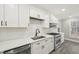 Beautiful white kitchen featuring stainless steel appliances and modern backsplash at 4436 Talcott Dr, Durham, NC 27705
