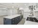 Modern kitchen with a large island, granite countertops, stainless steel appliances, and ample storage at 4436 Talcott Dr, Durham, NC 27705