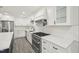 Modern kitchen with stainless steel appliances, quartz countertop, and white cabinets at 4436 Talcott Dr, Durham, NC 27705