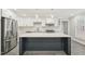 Modern kitchen with stainless steel appliances, a large island, and white cabinets at 4436 Talcott Dr, Durham, NC 27705