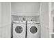 Convenient laundry room with a modern, side-by-side washer and dryer unit at 4436 Talcott Dr, Durham, NC 27705