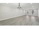 Spacious open floor plan showcasing recessed lighting, light gray walls, and expansive gray wood floors at 4436 Talcott Dr, Durham, NC 27705