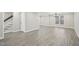 A large living room with gray wood flooring and natural light at 4436 Talcott Dr, Durham, NC 27705