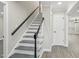 Staircase with black handrail and gray steps at 4436 Talcott Dr, Durham, NC 27705