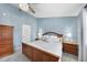 Bedroom featuring a ceiling fan, light-gray walls, wooden bed and two nightstands at 5 Bonham Ct, Durham, NC 27703