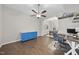 Open living area featuring wood floors, a ceiling fan, and a stylish blue accent cabinet at 5 Bonham Ct, Durham, NC 27703