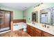 Well-lit bathroom featuring double sinks, glass enclosed shower, and separate soaking tub at 532 Front Ridge Dr, Cary, NC 27519