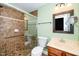 Bathroom featuring glass-enclosed shower, single sink vanity with decorative mirror at 532 Front Ridge Dr, Cary, NC 27519