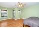 A furnished bedroom with hardwood floors and a ceiling fan offers a comfortable retreat at 532 Front Ridge Dr, Cary, NC 27519