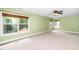 Bright bedroom with three large windows, neutral carpet, ceiling fan, and light green walls at 532 Front Ridge Dr, Cary, NC 27519