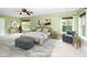 Large bedroom with neutral carpet, large windows, ceiling fan, and staged furniture create a relaxing retreat at 532 Front Ridge Dr, Cary, NC 27519