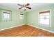 Sunlit bedroom with hardwood floors, ceiling fan, and ample windows for natural light at 532 Front Ridge Dr, Cary, NC 27519