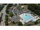 Aerial view showcasing the community pool, tennis courts, playground, and parking at 532 Front Ridge Dr, Cary, NC 27519