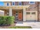 Charming home showcasing stone detailing, a covered porch, and manicured landscaping at 532 Front Ridge Dr, Cary, NC 27519