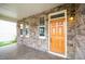 Inviting covered front porch with stone accents, warm lighting, and tiled flooring at 532 Front Ridge Dr, Cary, NC 27519
