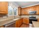 Kitchen area featuring wood cabinets, stone countertops, and stainless steel appliances at 532 Front Ridge Dr, Cary, NC 27519
