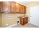 Laundry area features upper cabinets, a folding counter, and tile floors at 532 Front Ridge Dr, Cary, NC 27519