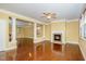 Open living room features a fireplace, hardwood floors, and decorative columns at 532 Front Ridge Dr, Cary, NC 27519