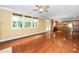 Bright living room with hardwood floors, large windows, and an open connection to the kitchen at 532 Front Ridge Dr, Cary, NC 27519