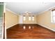 Bright living room with hardwood floors, staircase, and neutral wall colors at 532 Front Ridge Dr, Cary, NC 27519