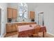 Bright dining area features natural wood cabinetry, quartz countertops, and a large arched window at 800 White Meadows Dr, Fuquay Varina, NC 27526