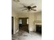 Living room featuring vintage ceiling fan and decorative fireplace at 813 N Main St, Burlington, NC 27217