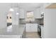 Bright kitchen offers white cabinetry, modern fixtures, and granite countertops at 819 Springdale Dr, Durham, NC 27707