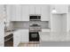 Well-equipped kitchen with stainless steel appliances, granite countertops, and white cabinetry at 819 Springdale Dr, Durham, NC 27707