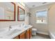 Bathroom features double vanity, wood trimmed mirrors, and modern fixtures at 9132 Sanctuary Ct Ct, Raleigh, NC 27617