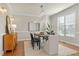 Bright dining room with hardwood floors, chandelier, and large window at 9132 Sanctuary Ct Ct, Raleigh, NC 27617