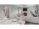 Bright living room with a fireplace, ceiling fan, and contemporary furniture at 15 Merle Dr, Wendell, NC 27591
