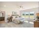 Spacious main bedroom with large windows offering natural light and views of the green landscape at 15 Merle Dr, Wendell, NC 27591