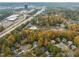 An aerial view shows a neighborhood with mature trees, and a nearby highway at 10 Marchmont Ct, Durham, NC 27705