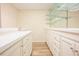 Basement bar area with sink, cabinets, new flooring, and mirrored shelving at 10 Marchmont Ct, Durham, NC 27705