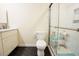 Clean bathroom features a marble countertop, dark floor tiles, and a glass-enclosed shower at 10 Marchmont Ct, Durham, NC 27705