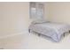 Minimalist bedroom featuring carpet flooring, a window, and neutral wall paint at 10 Marchmont Ct, Durham, NC 27705