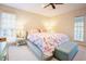 Bright bedroom with a floral bedspread and a cushioned bench at the foot of the bed at 10 Marchmont Ct, Durham, NC 27705