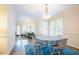 Bright dining area featuring hardwood floors, chandelier, and an open view into the living room at 10 Marchmont Ct, Durham, NC 27705