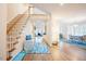 Spacious home entryway featuring hardwood floors, staircase, and views into the living spaces at 10 Marchmont Ct, Durham, NC 27705