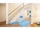 Bright foyer features a staircase with wooden handrail, hardwood flooring, and stylish accents at 10 Marchmont Ct, Durham, NC 27705